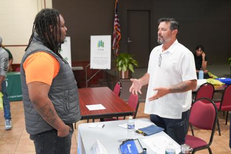 A job seeker meets with a hiring manager during a Section 3 Job Fair